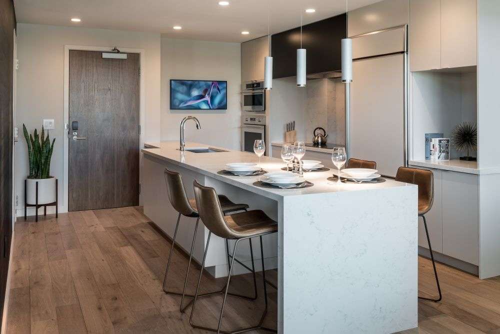 a room featuring a table with plates and glasses on top of it