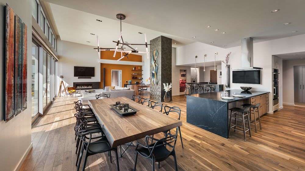 a room with multiple tables and chairs
