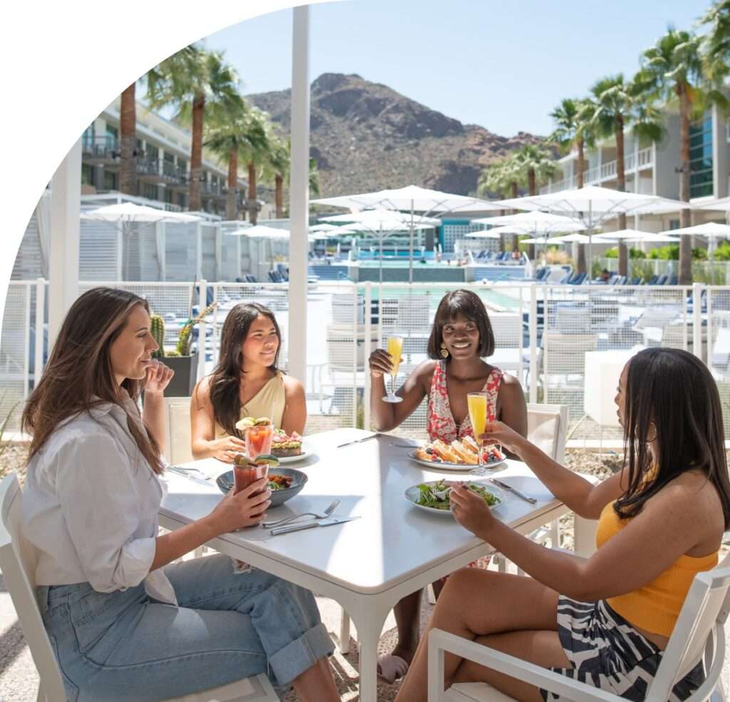 Four women enjoying drinks and food at Mountain Shadows.