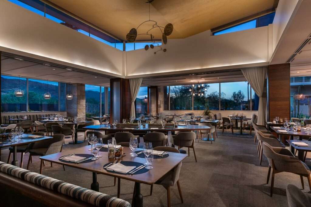 a dining room with multiple tables and chairs