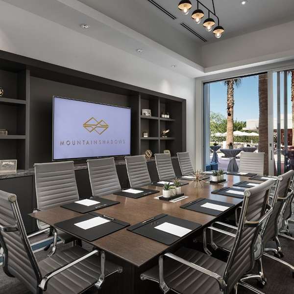 Conference room with large screen and chairs.