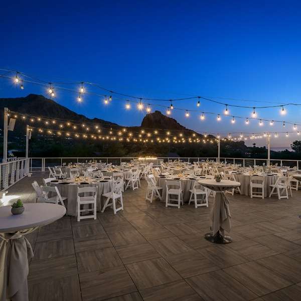 Outdoor wedding reception at Mountain Shadows, adorned with string lights and elegant tables.