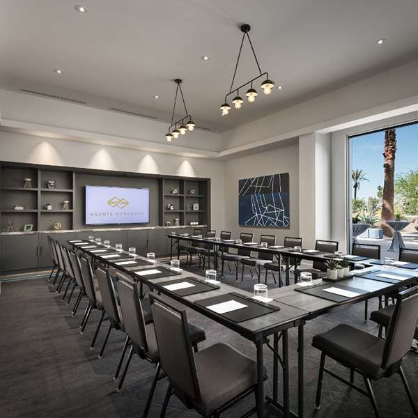 Conference room with large screen and chairs.