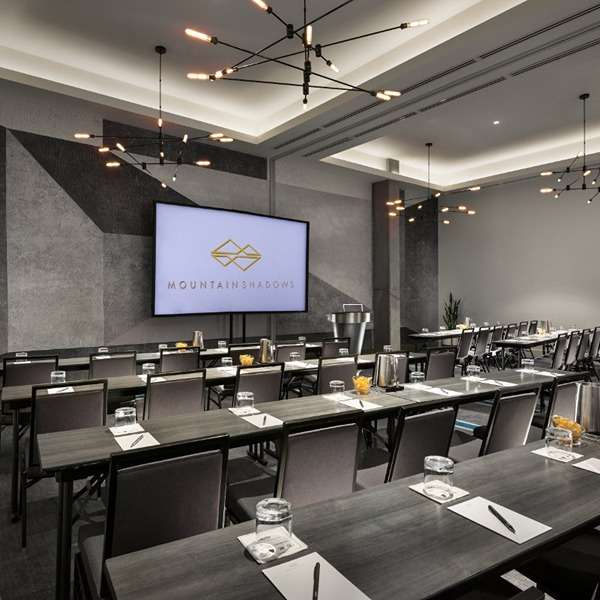 Conference room with tables and chairs arranged for a meeting at Mountain Shadows.