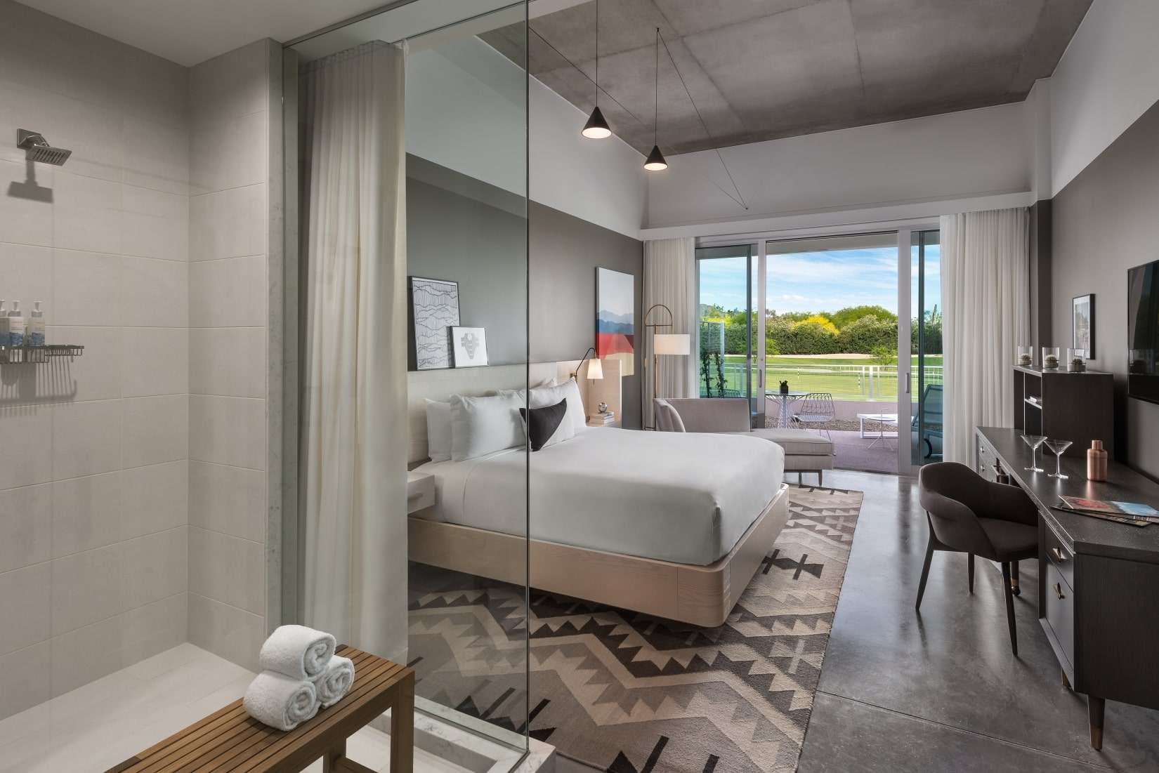 a room featuring a bed and glass door that goes outside