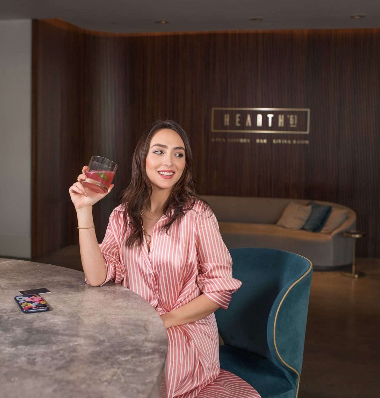woman sitting at the bar with a cocktail